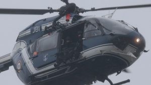 A helicopter of the French Gendarmerie flies over Dammartin-en-Goele where a hostage-taking was underway after police hunting the Islamist brothers who killed 12 people earlier this week exchanged fire with two men during a car chase, on January 9, 2015.  Friday's drama unfolded almost 48 hours into a massive manhunt launched after the brothers burst into the office of the satirical weekly Charlie Hebdo and gunned down staff members and two policemen, saying they were taking revenge for the magazine's publication of cartoons offensive to many Muslims. The number of people seized was not immediately confirmed. AFP PHOTO / JOEL SAGET