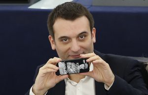 France's far-right National Front political party member and member of the European Parliament Philippot uses his mobile phone to take pictures of press photographers ahead of a voting session in Strasbourg